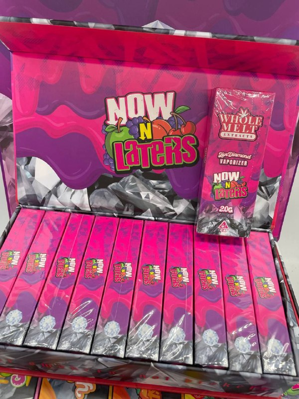A display box of "Import placeholder for 36" Life Diamond Vaporizers. The box is bright pink and purple, featuring several individual packages lined up neatly. The branding includes a colorful, playful design with a visible label stating "Whole Melk Hybrid" and "20G".