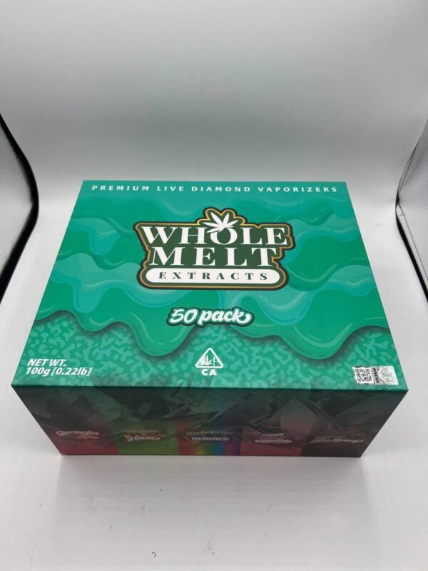 A green box labeled "Whole Melts Rainbow Berries" with "Premium Live Diamond Vaporizers" at the top. The box is specifically marked as a 50 pack with a net weight of 100g (10.221lb). Various product images are depicted across the bottom of the box.