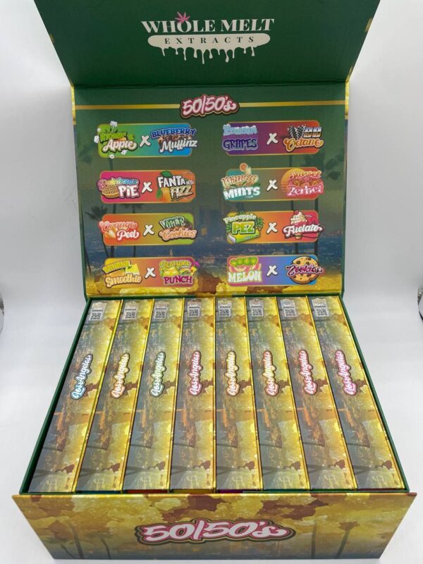 An open box displays multiple colorful vape cartridges from Whole Melt 50/50’s Resin series. Each cartridge is paired with a flavor from various brands, including Pez and Fanta. The packaging lists collaborations with different flavors and brands.