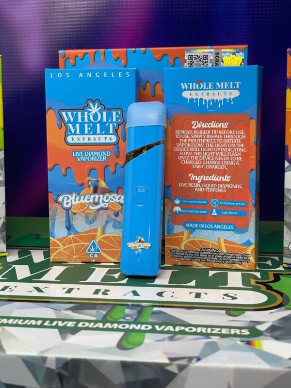 Image of a Whole Melt Extracts product display. The vibrant packaging shows a "Bluemosa" Live Diamond Vaporizer with a blue, portable vaporizer device. The box details product information, directions, and ingredients. Background features a colorful display.