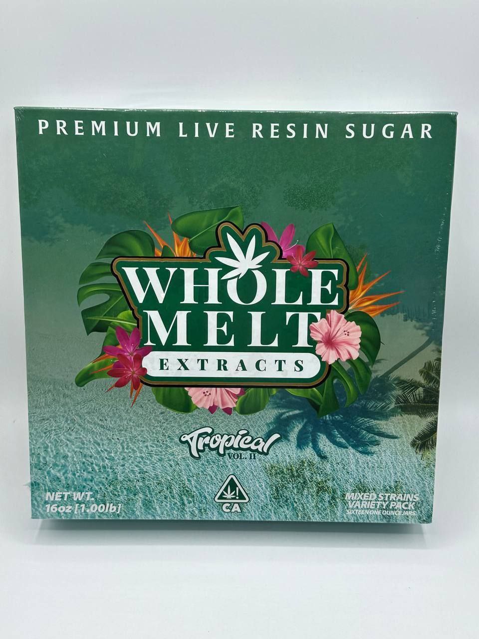 A green package labeled "Import placeholder for 24" with a tropical design featuring leaves and flowers. The brand, "Whole Melt Extracts," is prominently displayed in the center. The bottom reads "Tropical 90s 2.1," "Net Wt 16oz (1.00lb)," and "Mixed Strains Variety Pack.