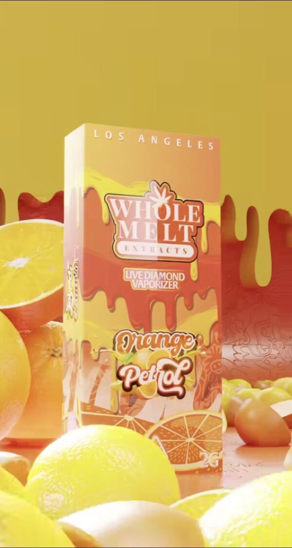 A box of Whole Melt Orange Petrol with mango flavor is surrounded by whole and sliced mangoes and lemons. The box features an orange and yellow color scheme with dripping text and graphics, set against a gradient background with the text "Los Angeles.